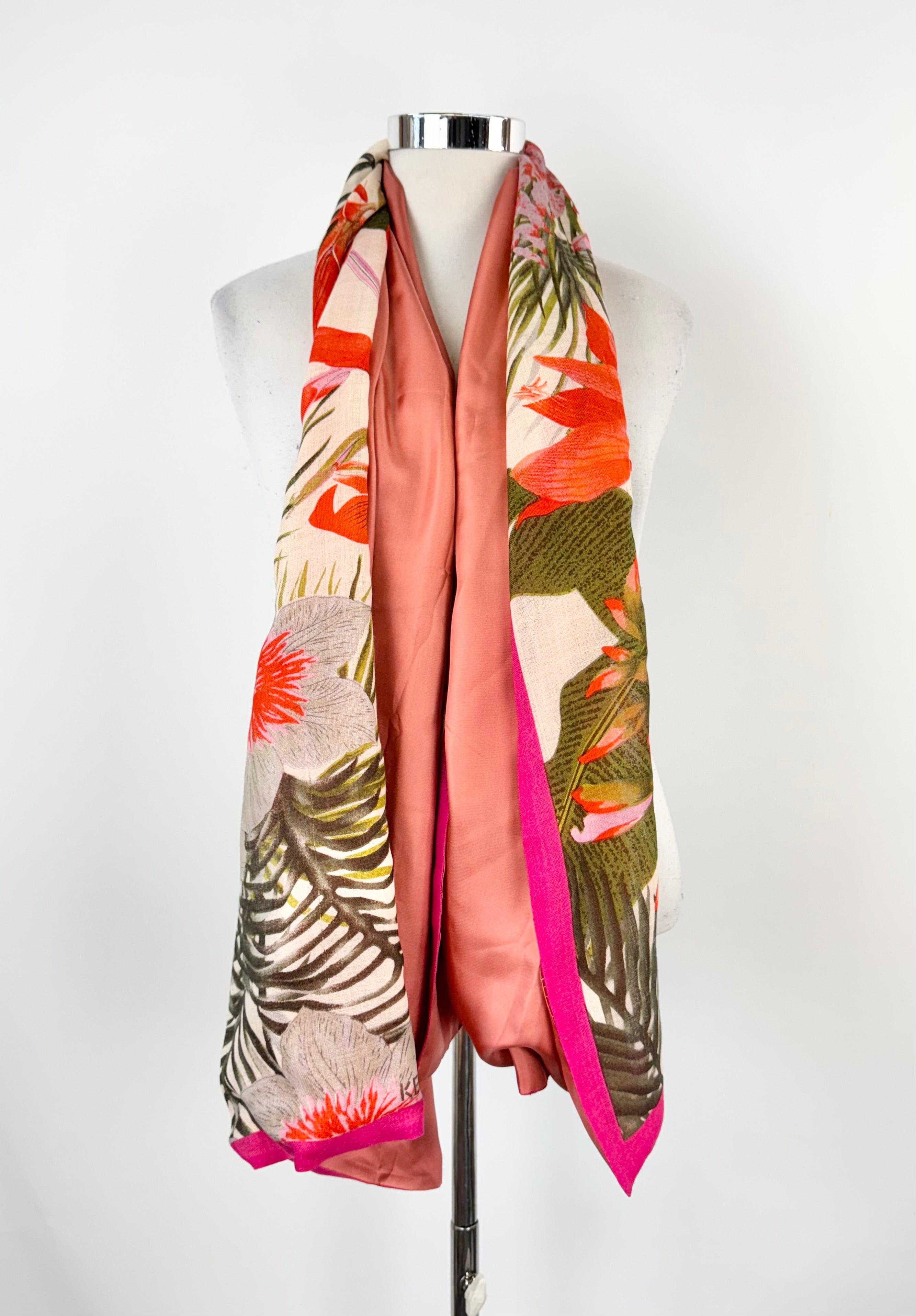 Colorful scarf with floral pattern on a mannequin against a white background