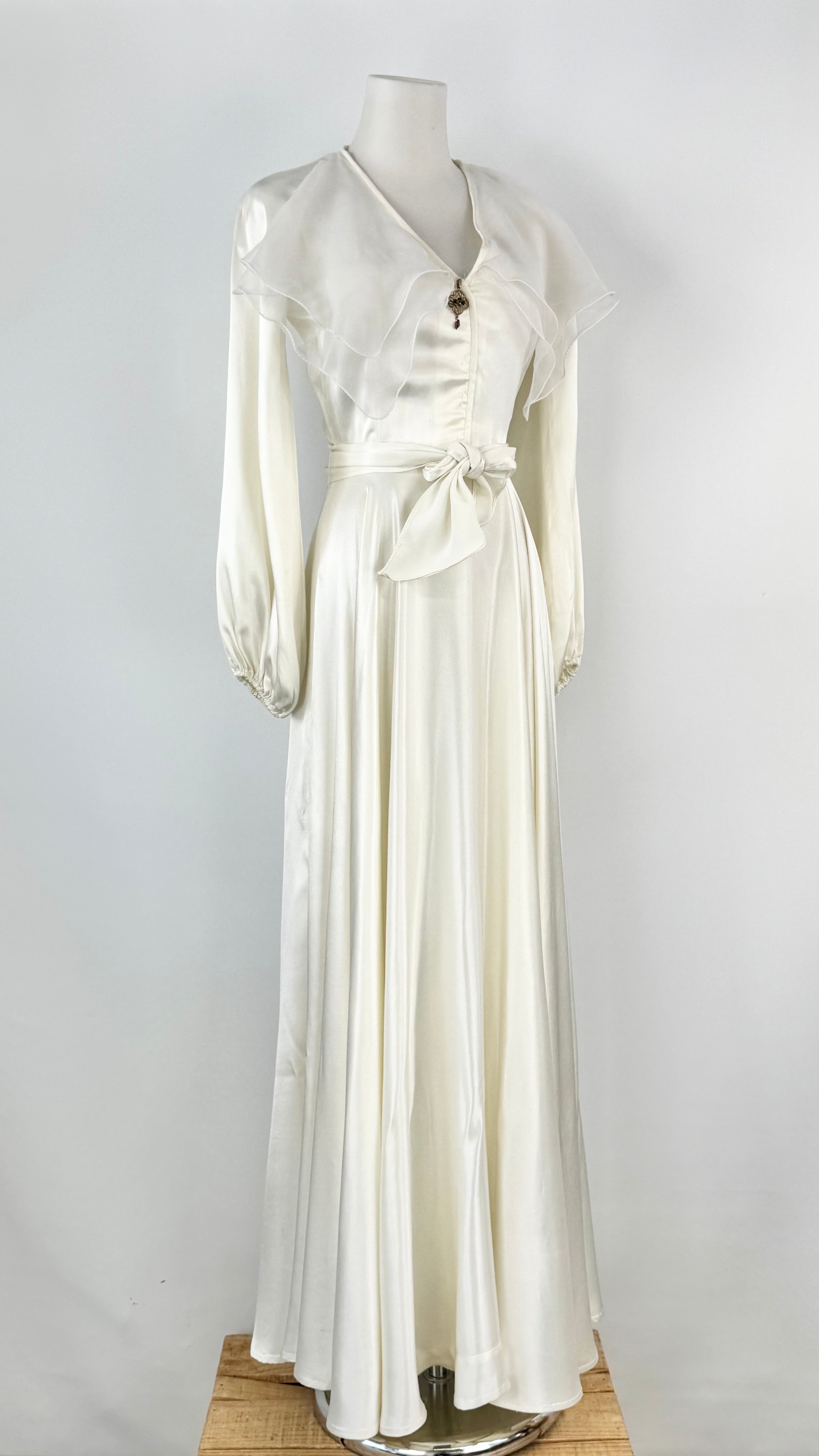 White dress on a mannequin against a plain background