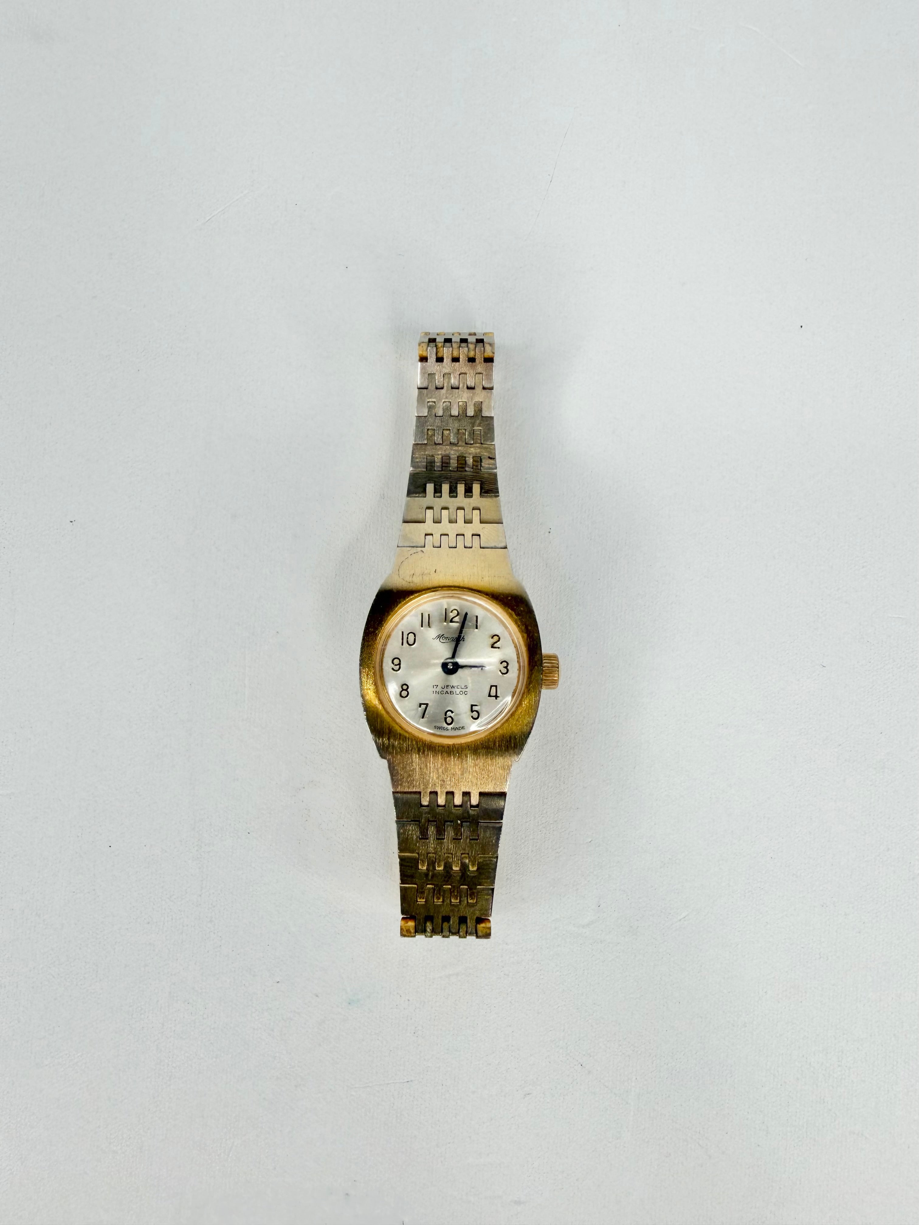 Gold and silver watch on a white background