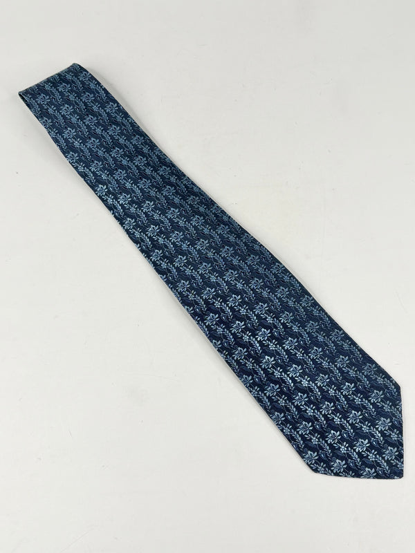 Blue patterned tie on a light gray background