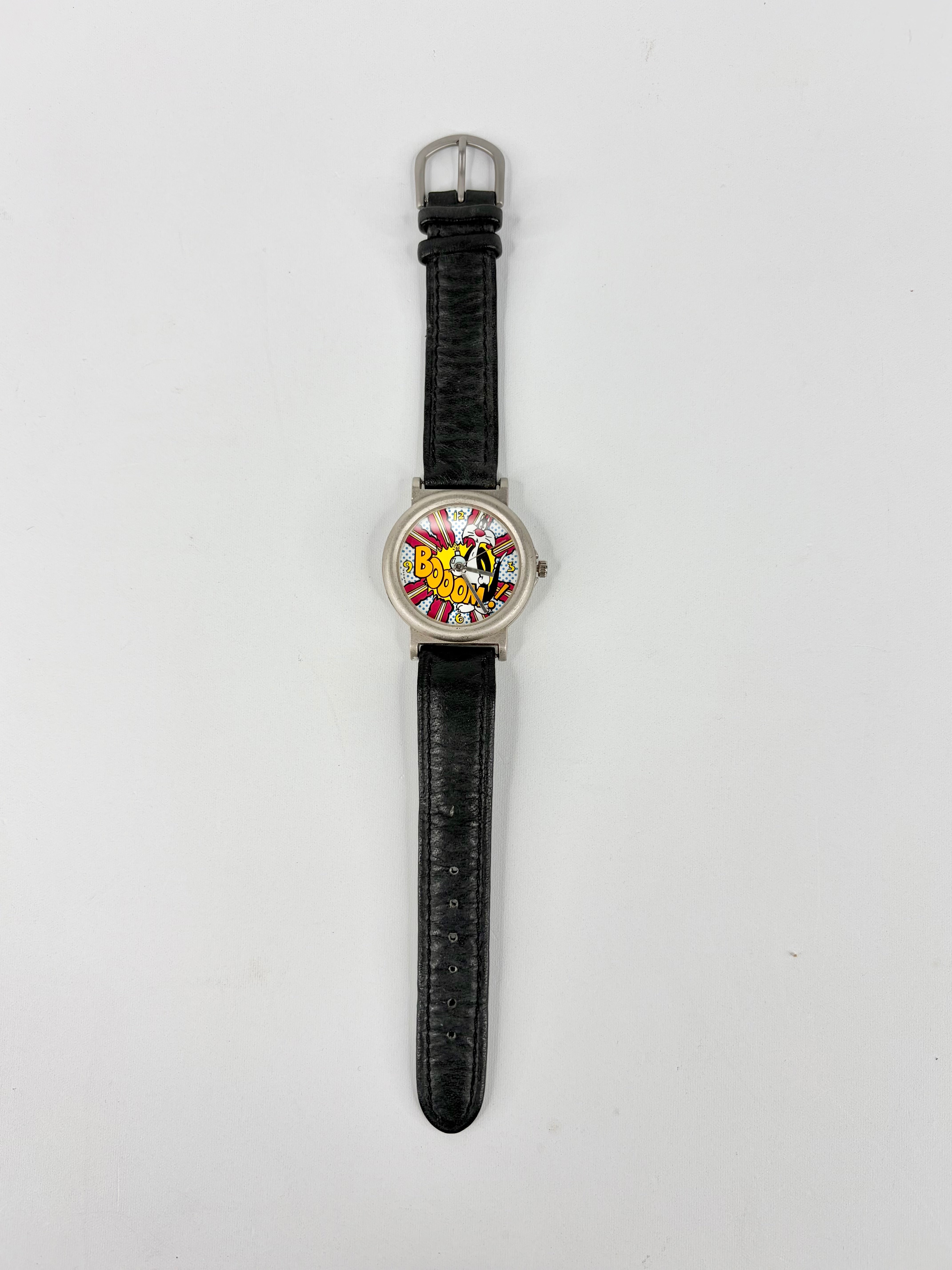 Watch with a black strap and colorful face on a white background