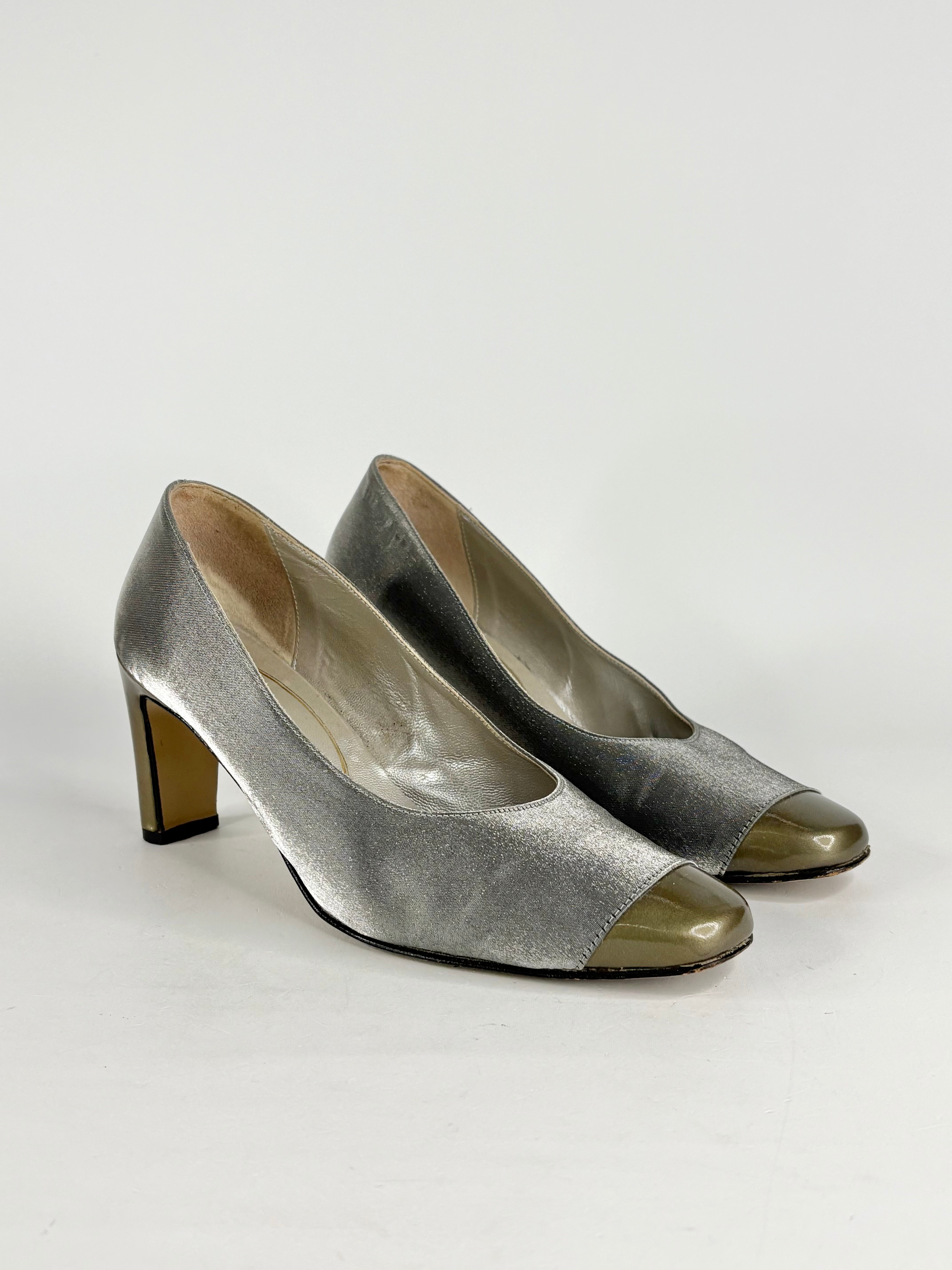 Pair of silver high-heeled shoes on a white background