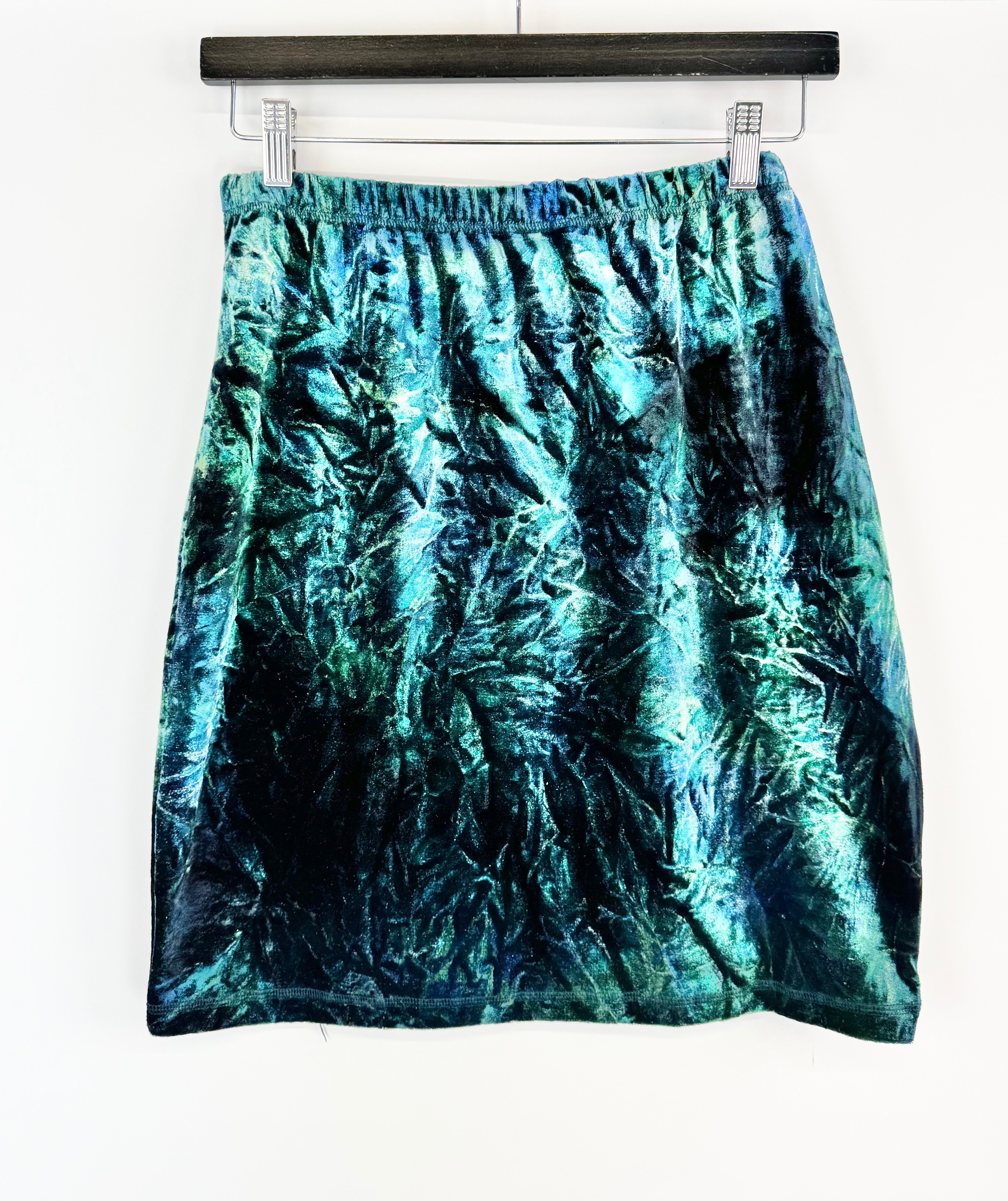 Blue tie-dye skirt hanging on a white background