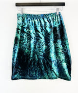 Blue tie-dye skirt hanging on a white background