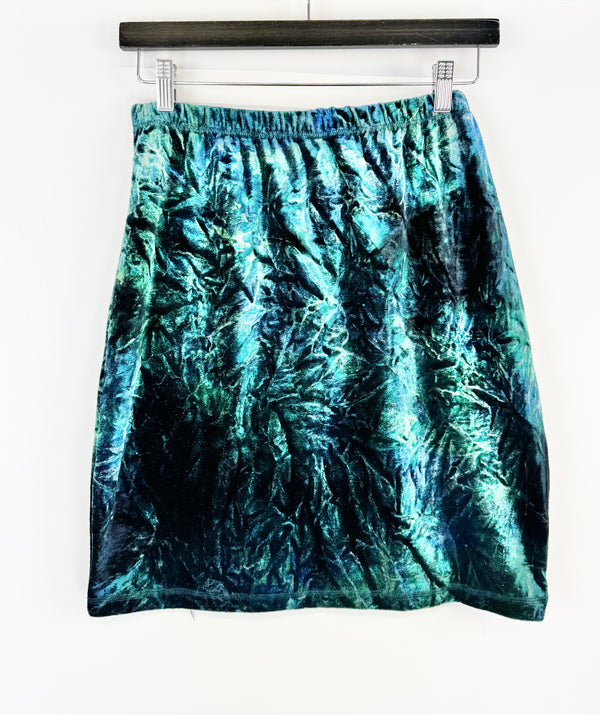 Blue tie-dye skirt hanging on a white background