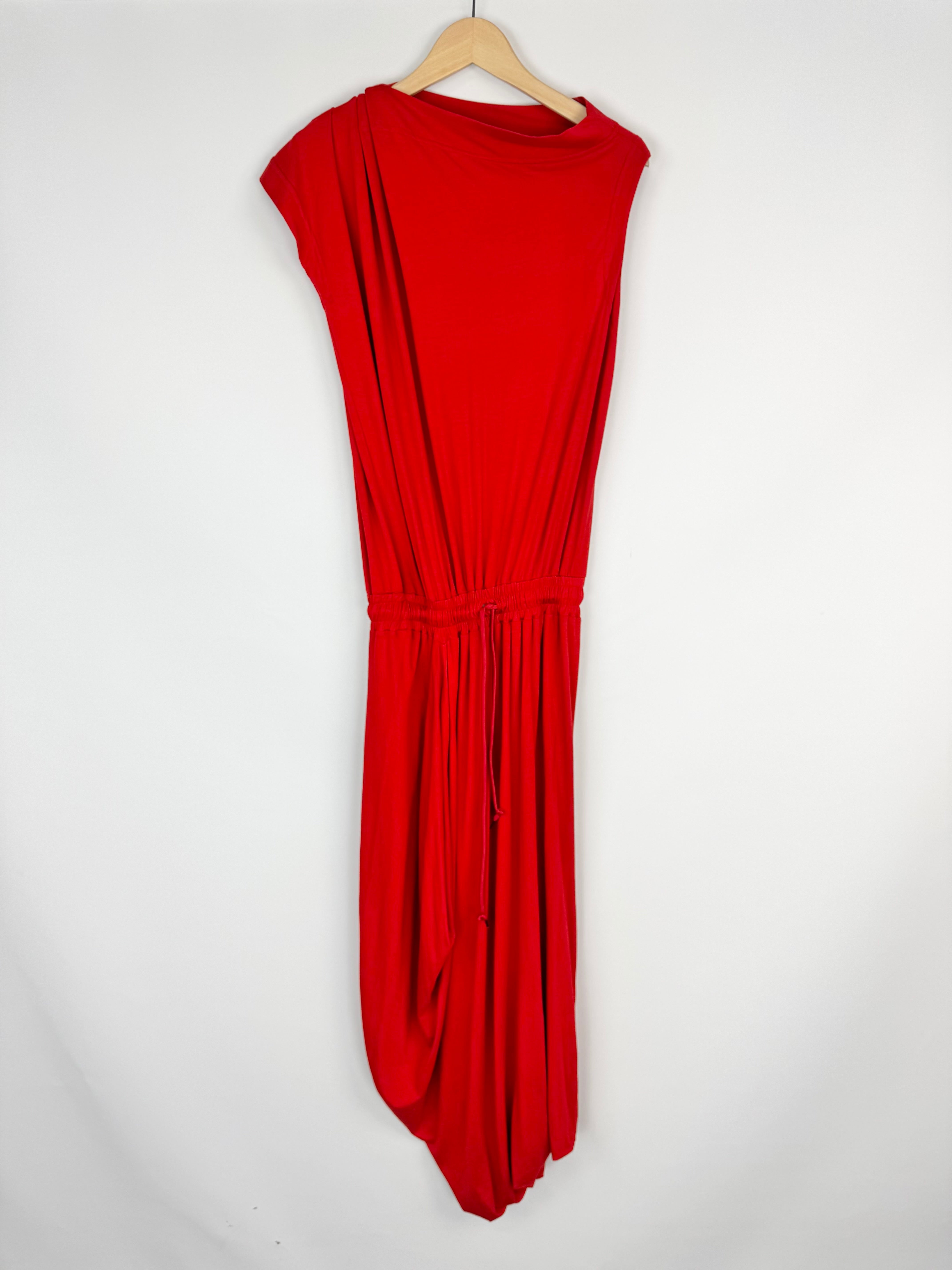Red dress on a hanger against a white background