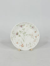 Decorative ceramic plate with floral design on a gray background