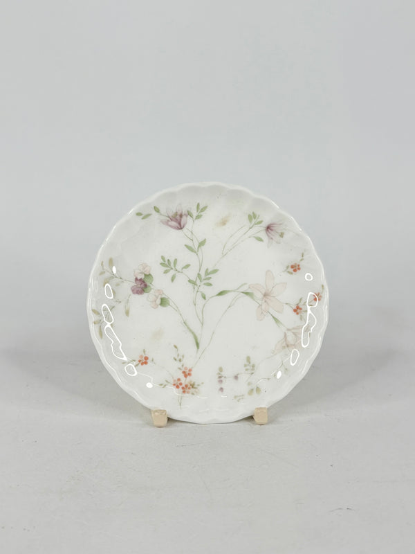 Decorative ceramic plate with floral design on a gray background