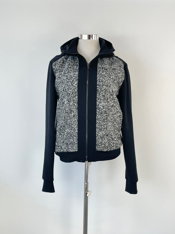 A hooded wool-blend jacket with black polyester trims, predominantly grey, by Korean label Wooyoungmi, displayed on a mannequin.