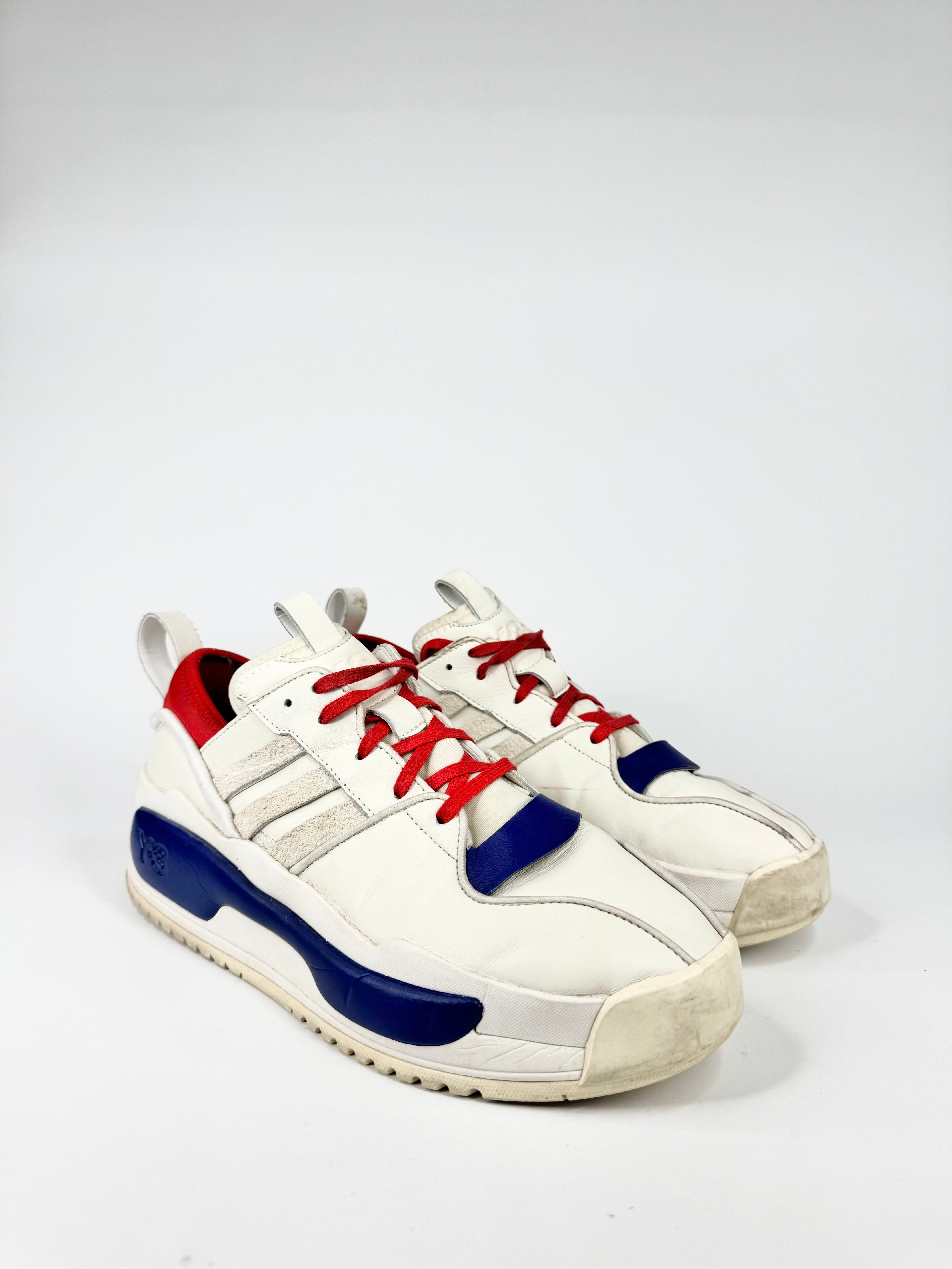 White sneakers with red and blue accents on a white background