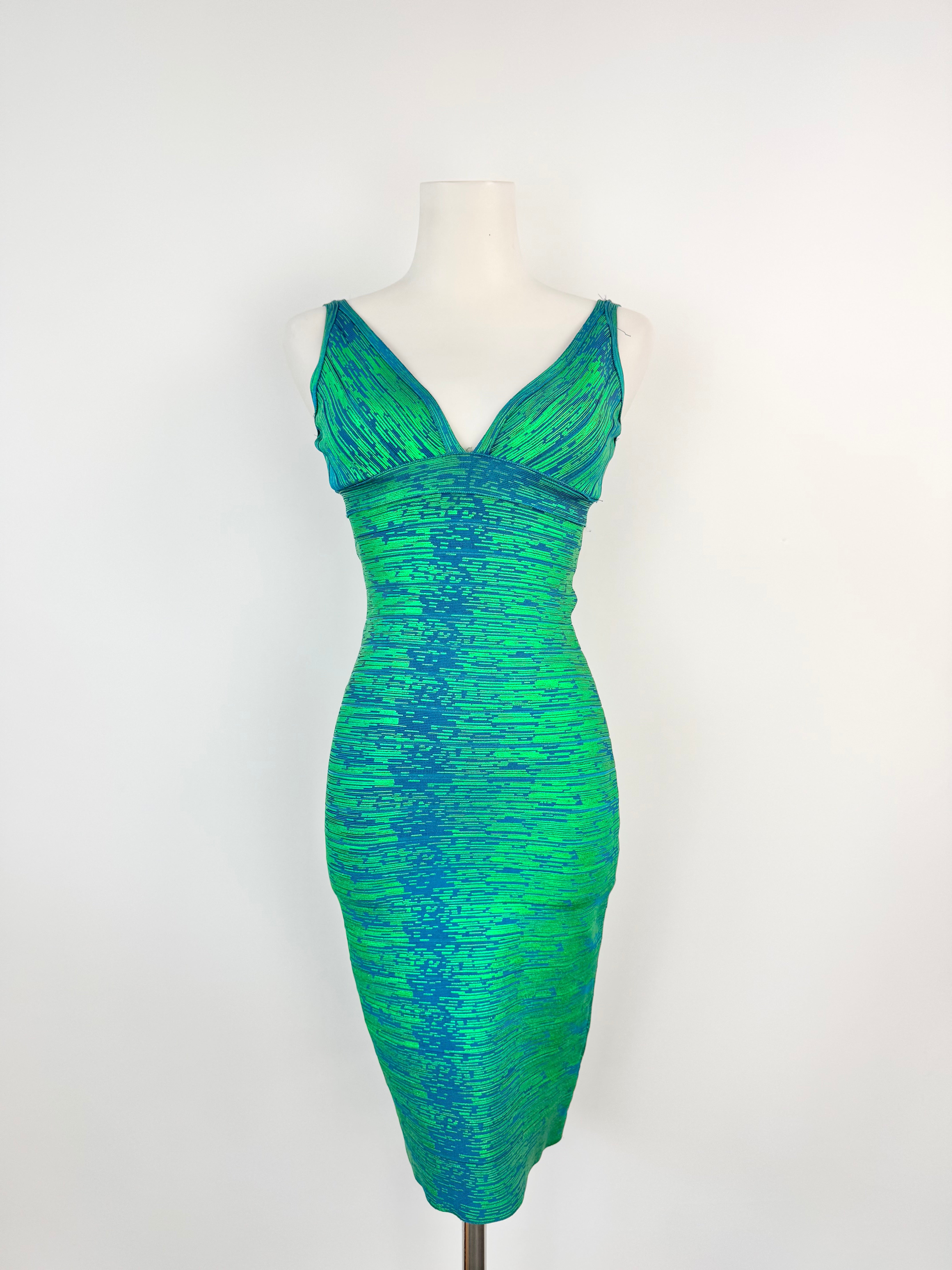 Green and blue patterned dress on a mannequin against a white background