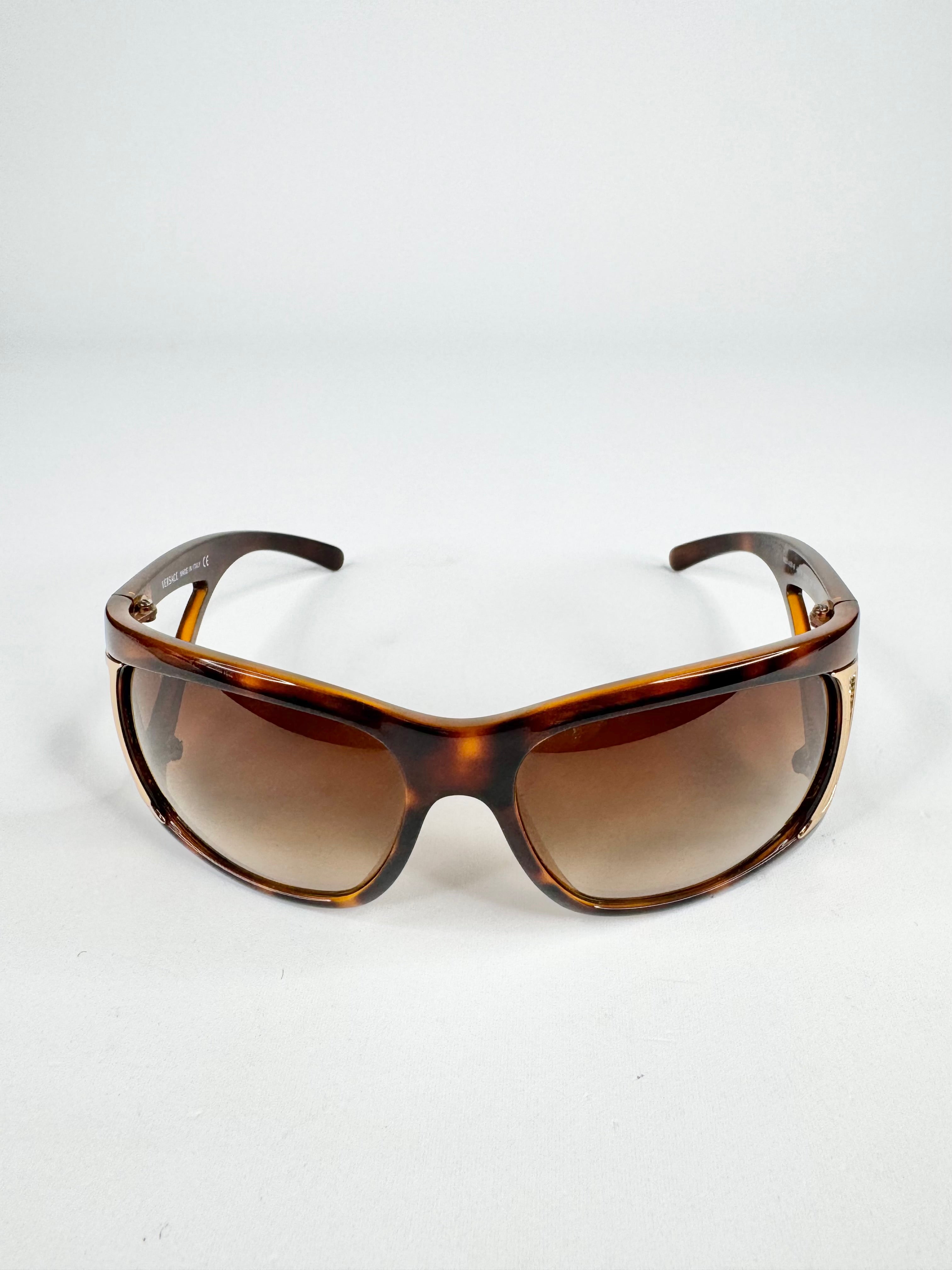 Sunglasses with tortoiseshell frame and brown lenses on a white background