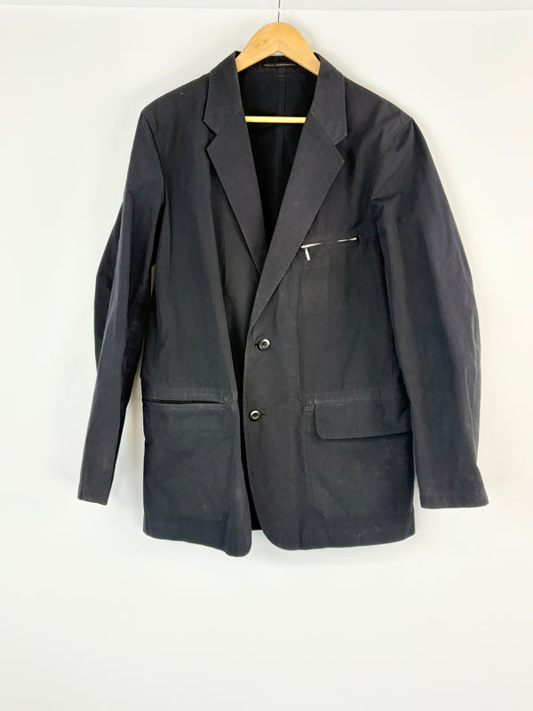 Black jacket on a hanger against a white background