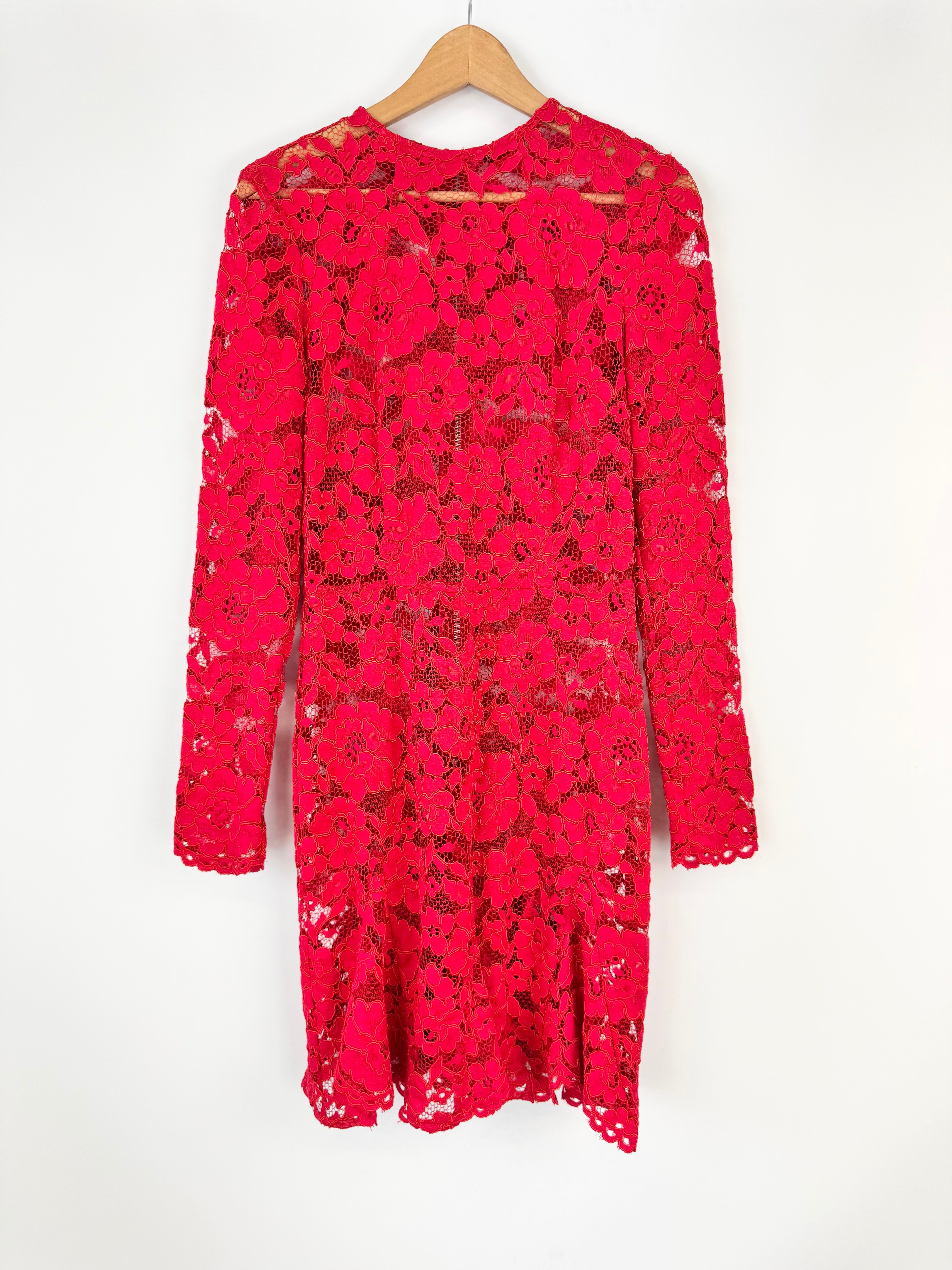 Red lace dress on a hanger against a white background