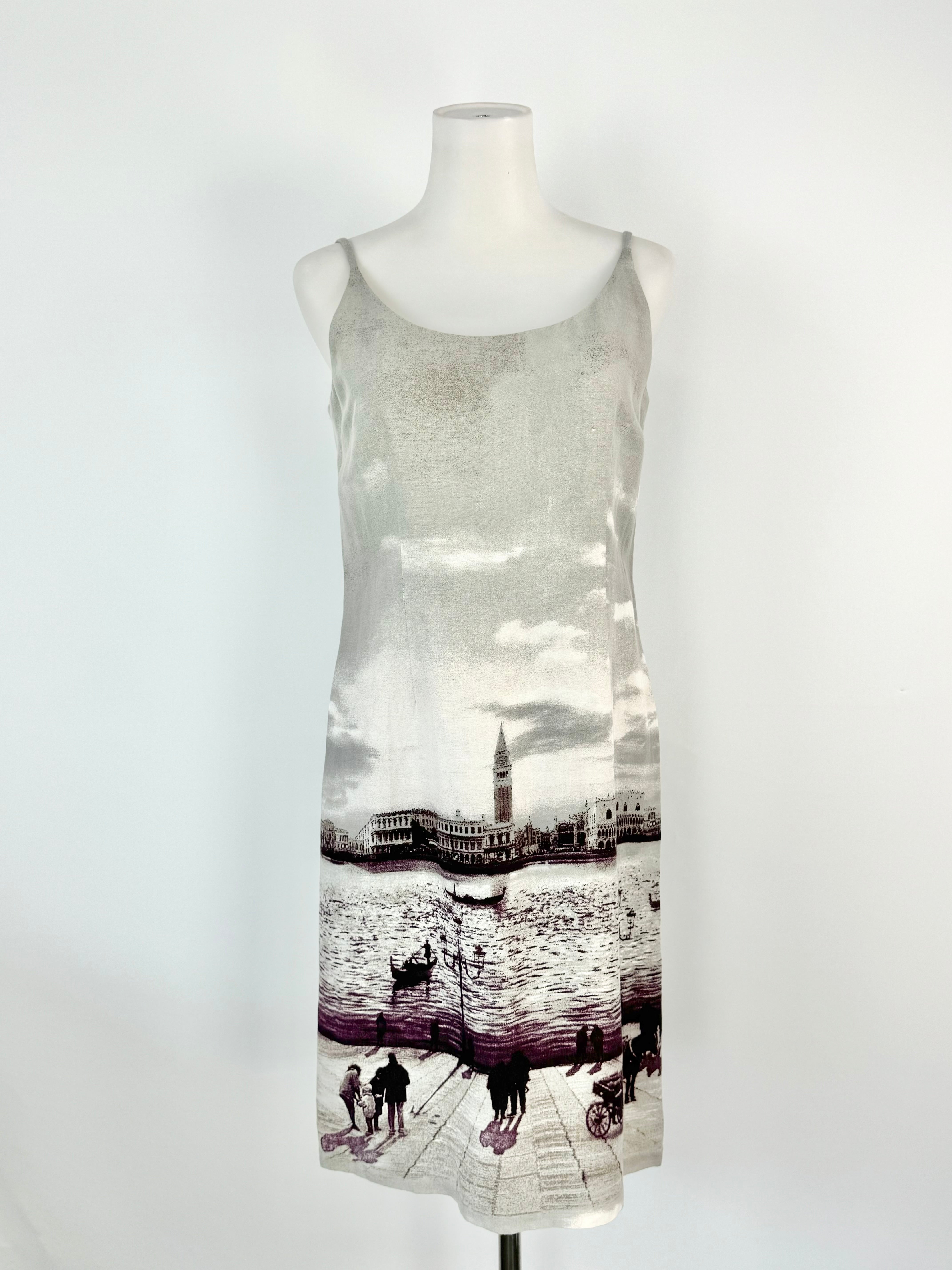 A grey linen blend slip dress with a cityscape print, displayed on a mannequin.