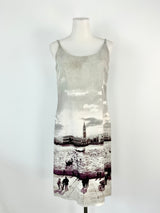 A grey linen blend slip dress with a cityscape print, displayed on a mannequin.