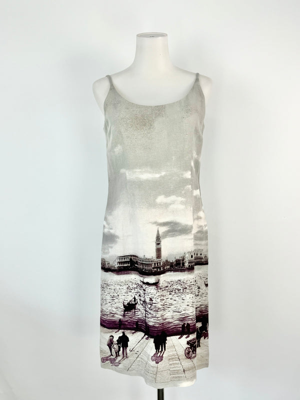 A grey linen blend slip dress with a cityscape print, displayed on a mannequin.