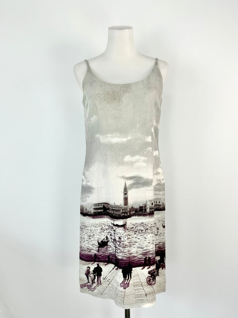A grey linen blend slip dress with a cityscape print, displayed on a mannequin.
